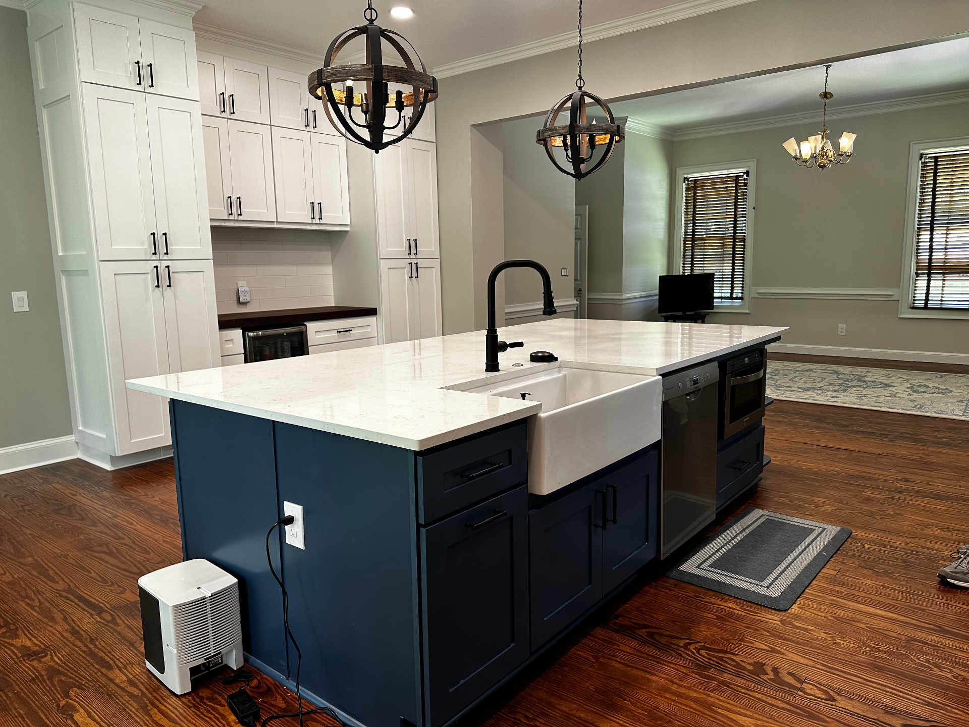 Kitchen remodel with blue island and white cabinetry