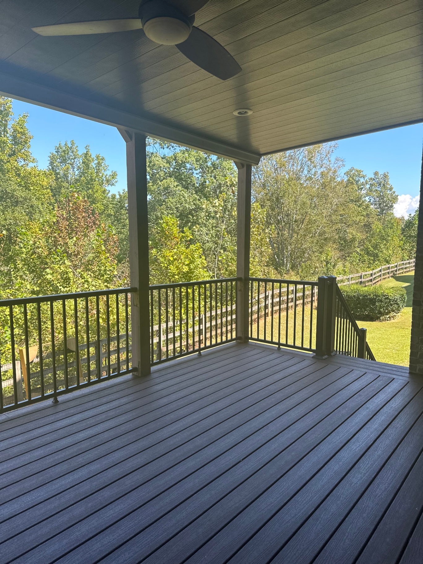 Covered porch with ceiling fan and composite floor
