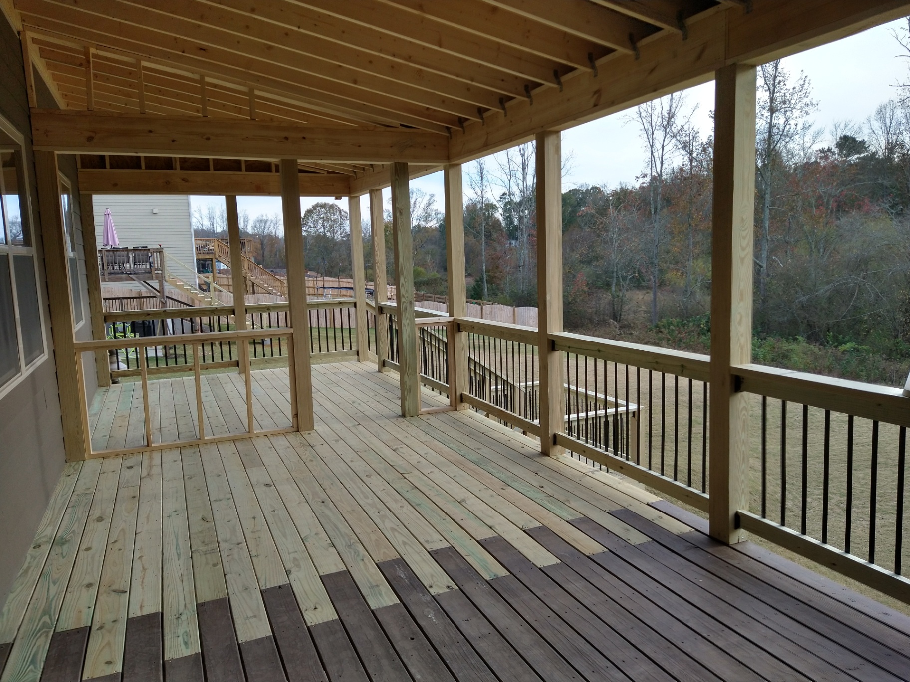 Covered porch with wood framing and rail