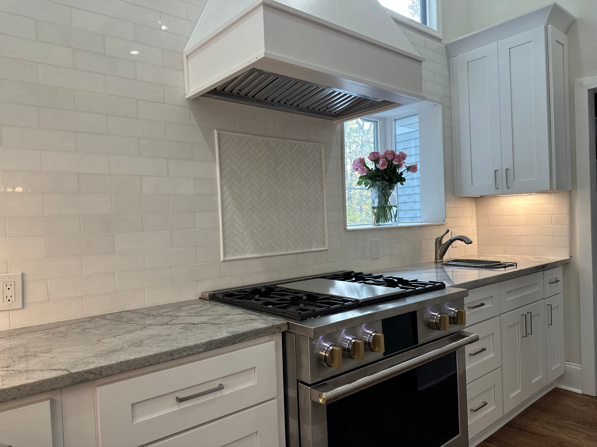 Custom backsplash and range detail in remodeled kitchen