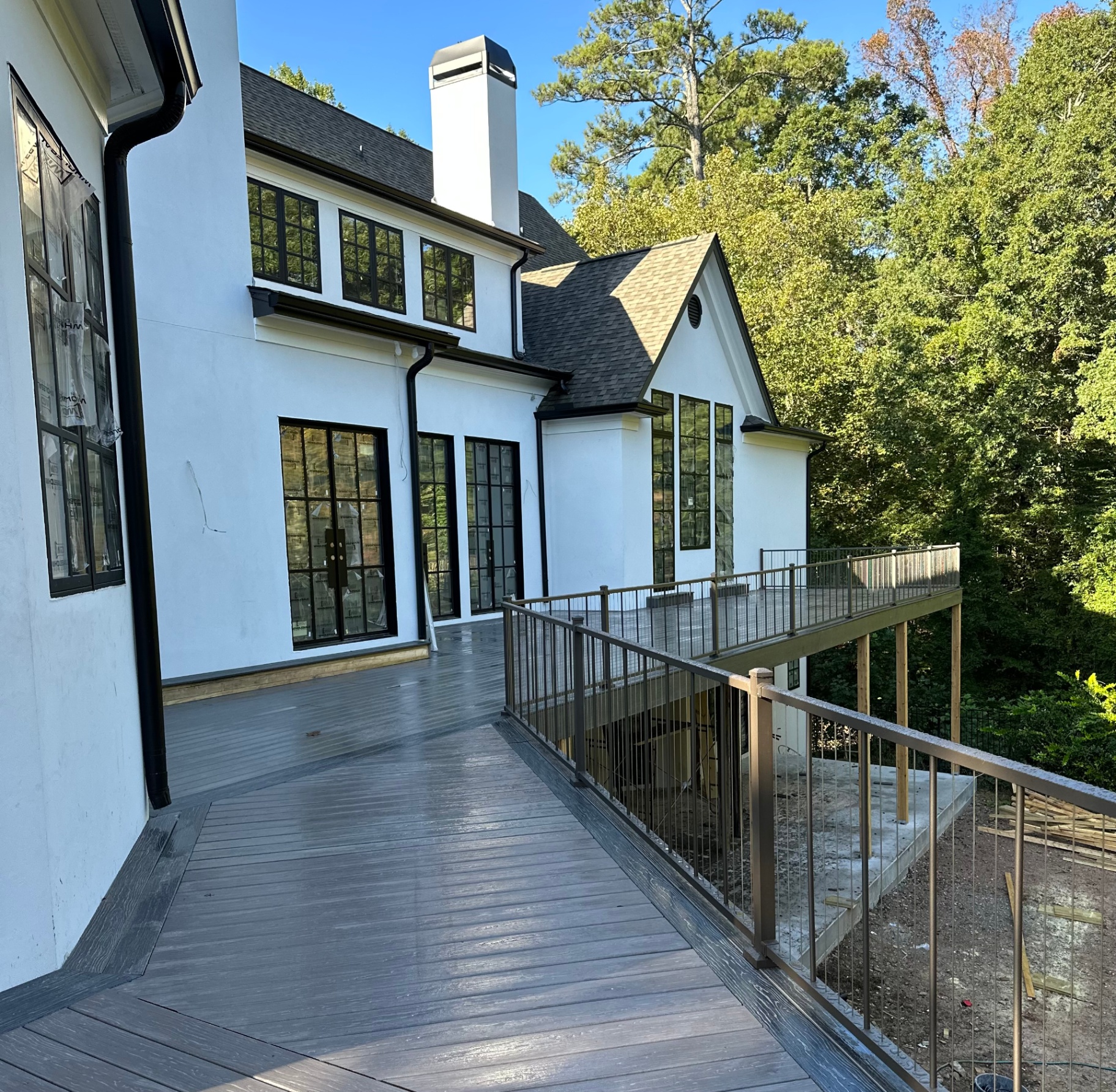 Modern multi-level deck on a white stucco home